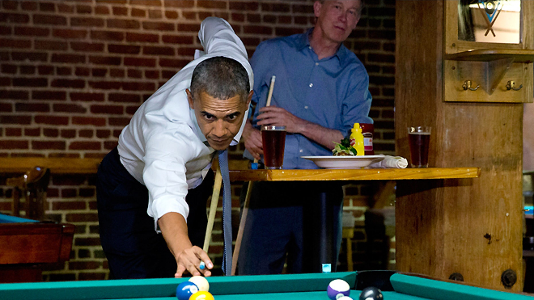 July 8, 2014: President Obama plays pool in Denver at Wynkoop Brewing Co. with Colorado Gov. John Hickenlooper.