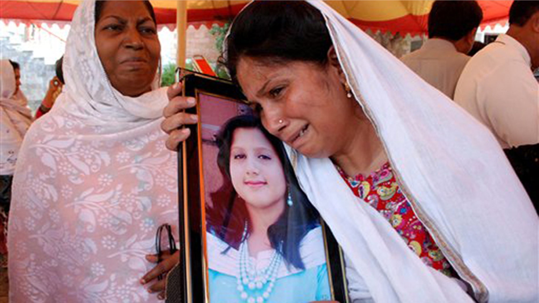 Sept. 24, 2013: A Pakistani Christian mother holds a picture of her daughter, who lost her life in a suicide bombing of the All Saints Church in the northwestern city of Peshawar, Pakistan. Pakistani Christians denounced the deadliest attack ever in this country against members of their faith when a pair of suicide bombers blew themselves up amid hundreds of worshippers outside a historic church in northwestern Pakistan on Sunday, Sept. 22, 2013.