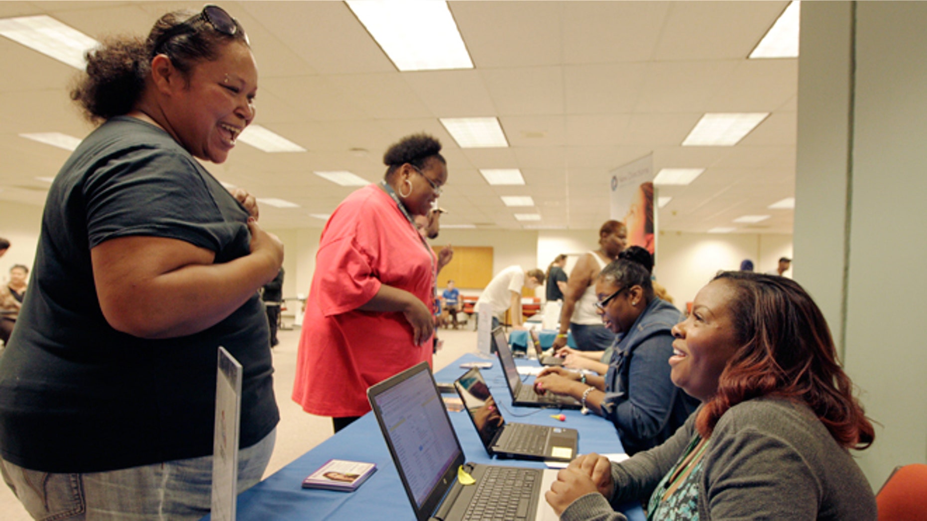 Aug. 27, 2014: Kelly Ragland, right, helps check in participants at the work experience program sponsored by the Ohio Association of Food Banks, in Columbus, Ohio. The work experience program helps participants gain valuable job skills and experience through volunteer service.