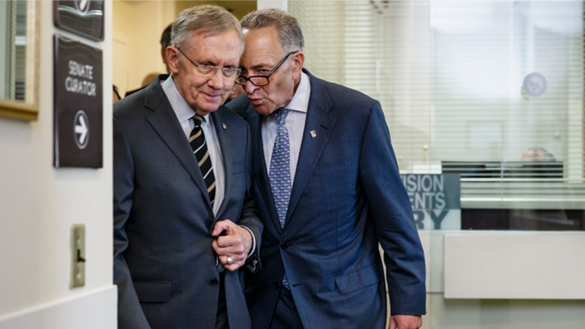 April 30, 2014: Sen. Charles Schumer, D-N.Y., the Democratic Policy Committee chairman, right, confers with Senate Majority Leader Harry Reid of Nev., on Capitol Hill in Washington, after a bill to raise the minimum wage was stopped in the Senate.