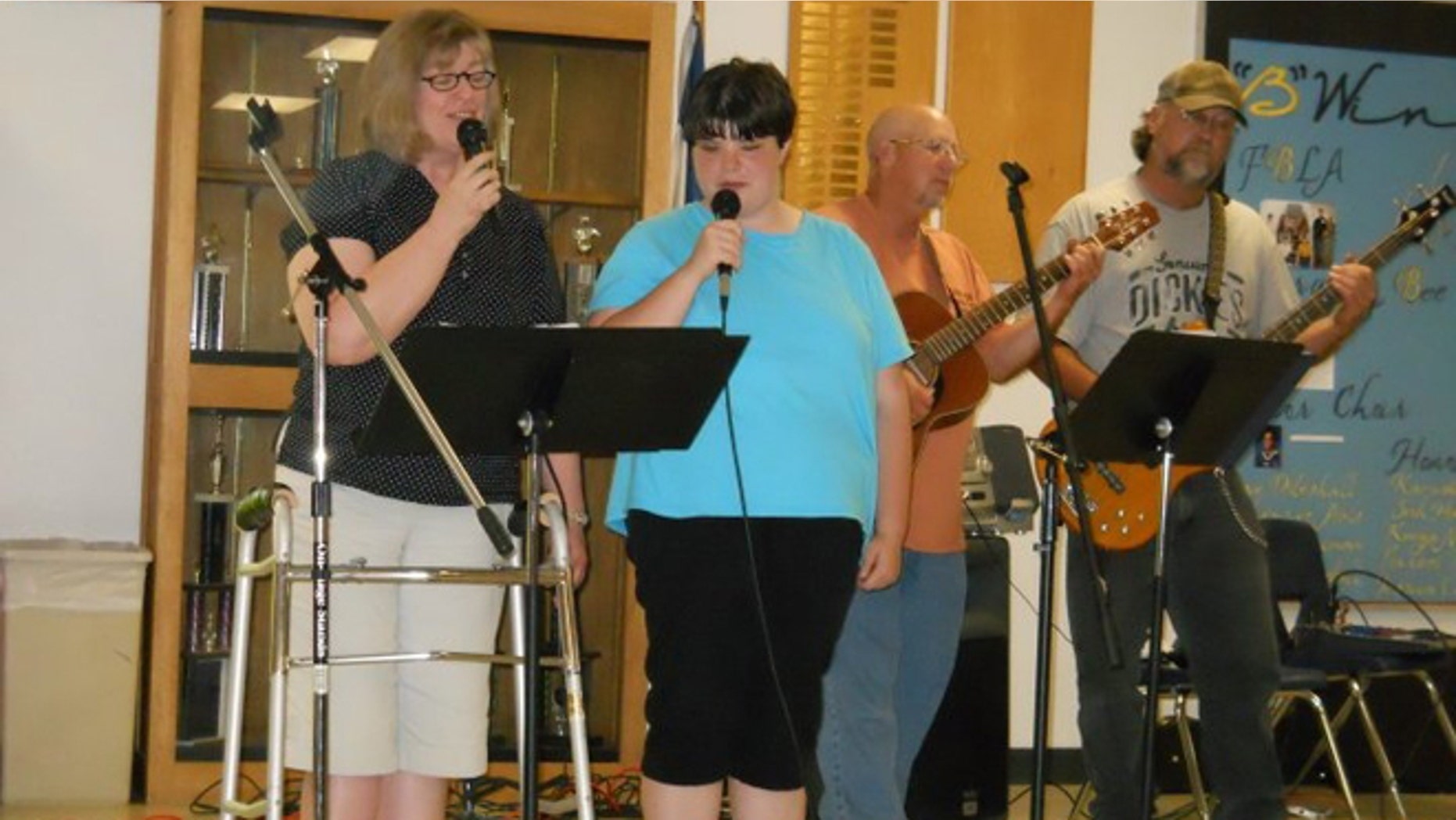 In this undated photograph Linda Baker, left, sings with her church praise team.
