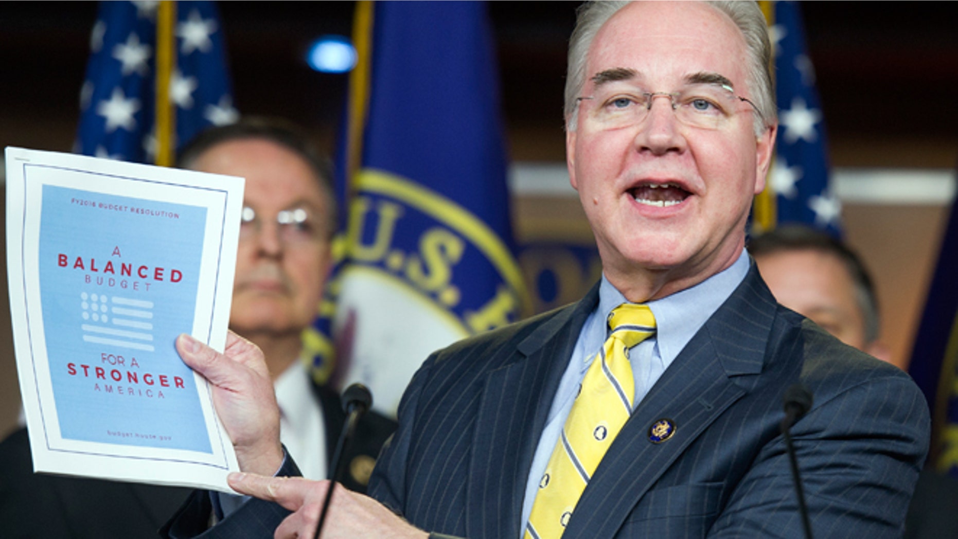 March 17, 2015: House Budget Committee Chairman Rep. Tom Price, R-Ga. holds-up a synopsis of the House Republican budget proposal as he announces the plan on Capitol Hill in Washington. The plan includes a boost in defense spending but cuts in the Medicaid program for the poor, food stamps and health care subsidies.