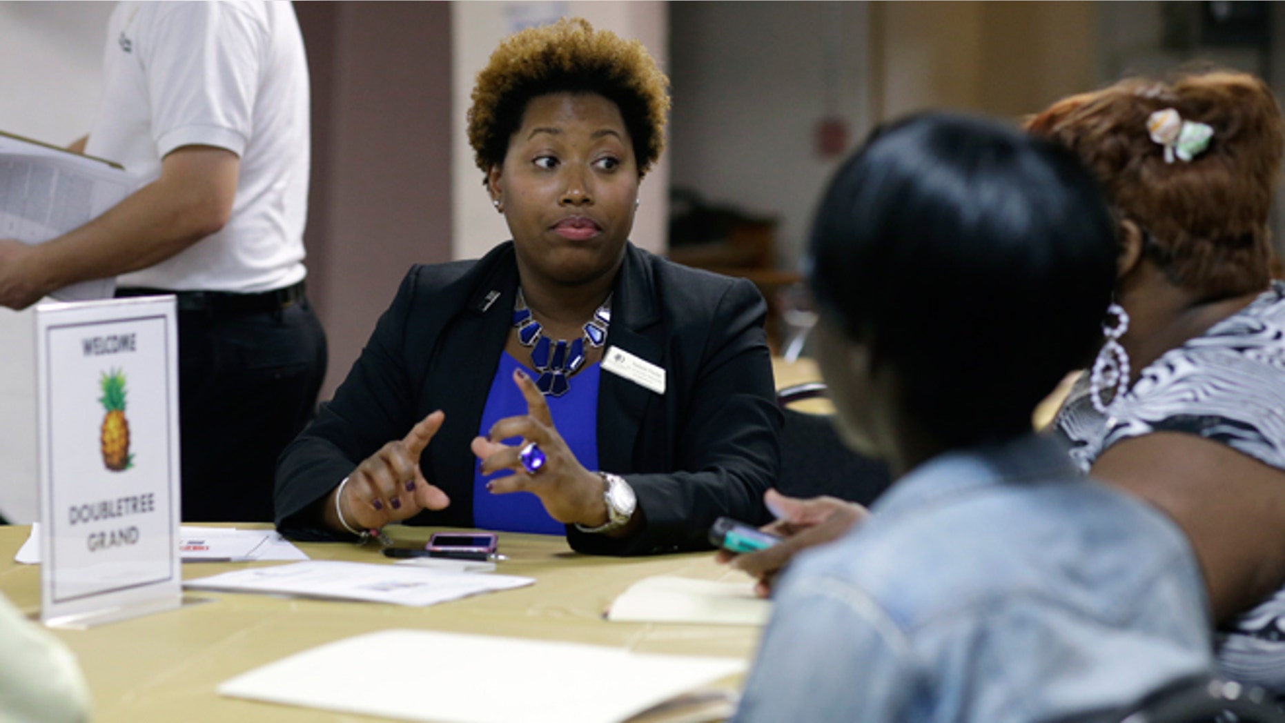 Jan. 23, 2015: Natalie Parker, director of human resources at the Doubletree Grand, left, talks with job applicants during a job fair at the Hospitality Institute.