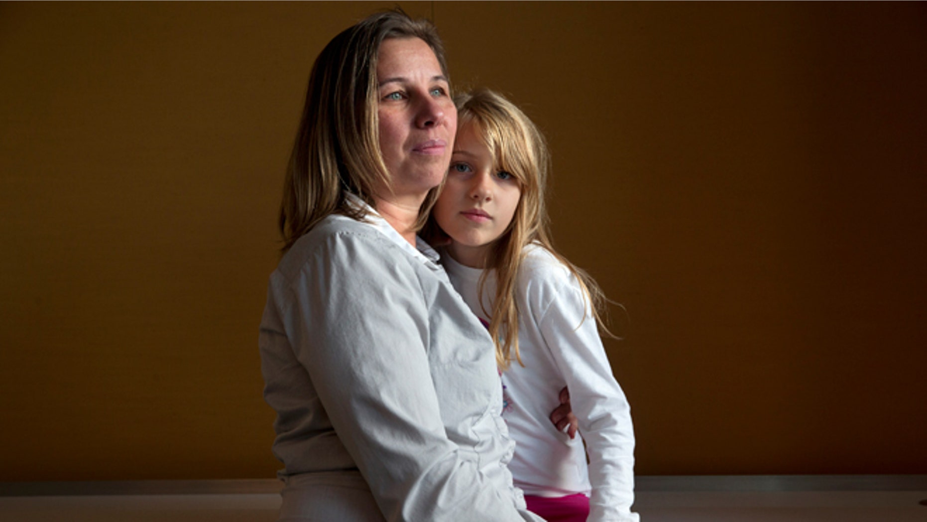 FILE -- Nov. 14, 2014: Peggy Young, of Lorton, Va., with her daughter Triniti, 7, in Washington. Young was pregnant when the company told her she could not have a temporary assignment to avoid lifting heavy packages, as her doctor ordered. She sued UPS for discriminating against pregnant women and, after losing two rounds in lower courts, the Supreme Court will hear her case on December 3.