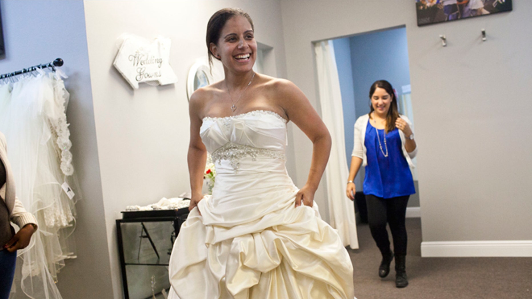 Nov. 13, 2013: Vanessa Gathers of Tampa tries on a dress during the "Operation Wedding Gown" event at The White Closet Bridal in Tampa. Gathers who is in the Air Force and her fiance in the Army will be getting married in December. Military wives who qualified we able to come and receive free wedding dresses. The bride or their spouse had to currently be serving in the military, be currently deployed, have a future deployment or deployed within the last 5 years. The event was a part of the Bride's Across America's campaign, "Operation Wedding Gown". The organization has donated over 10, 000 wedding gowns to military brides.