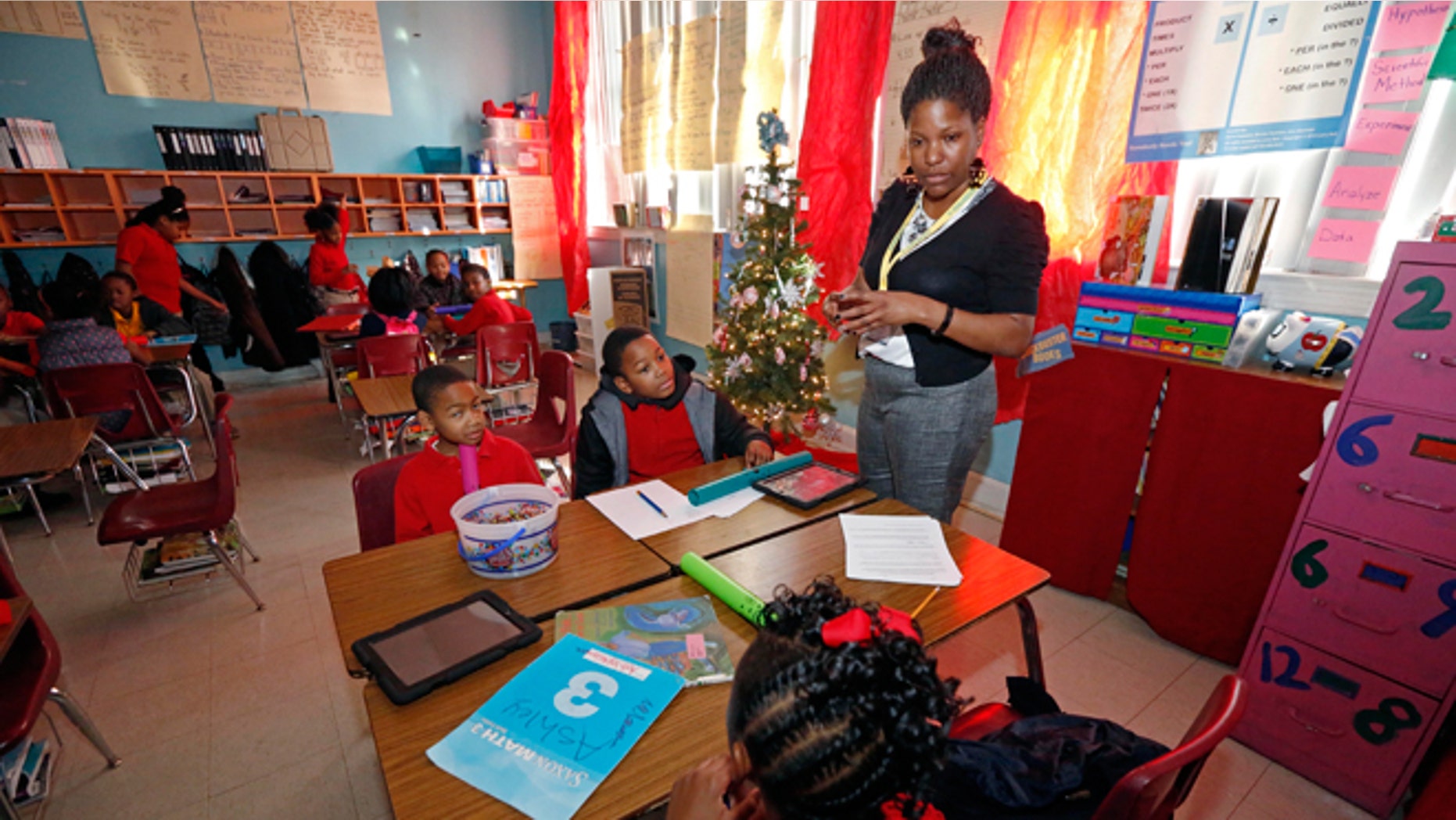 FILE -- Dec. 16, 2013: Chevonne Dixon, a fourth grade teacher at Tunica Elementary School in Tunica, Miss., speaks to the students about the elements of their blues song in class. Dixon leads her students into exploring the Delta’s homegrown music, a subtle way to apply this new Mississippi Blues Trail Curriculum into lessons for science, math, social studies and English.