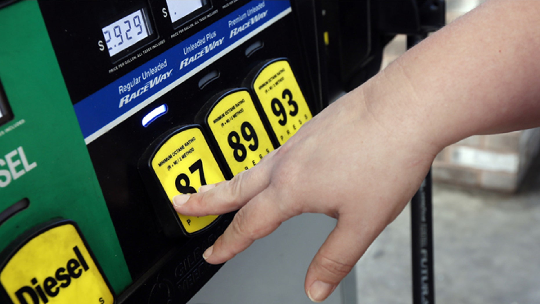 FILE -- Sept. 24, 2014: A customer reaches for the regular switch to fill her tank with the $2.92-a-gallon regular gas at a RaceWay gas station in Richland, Miss.