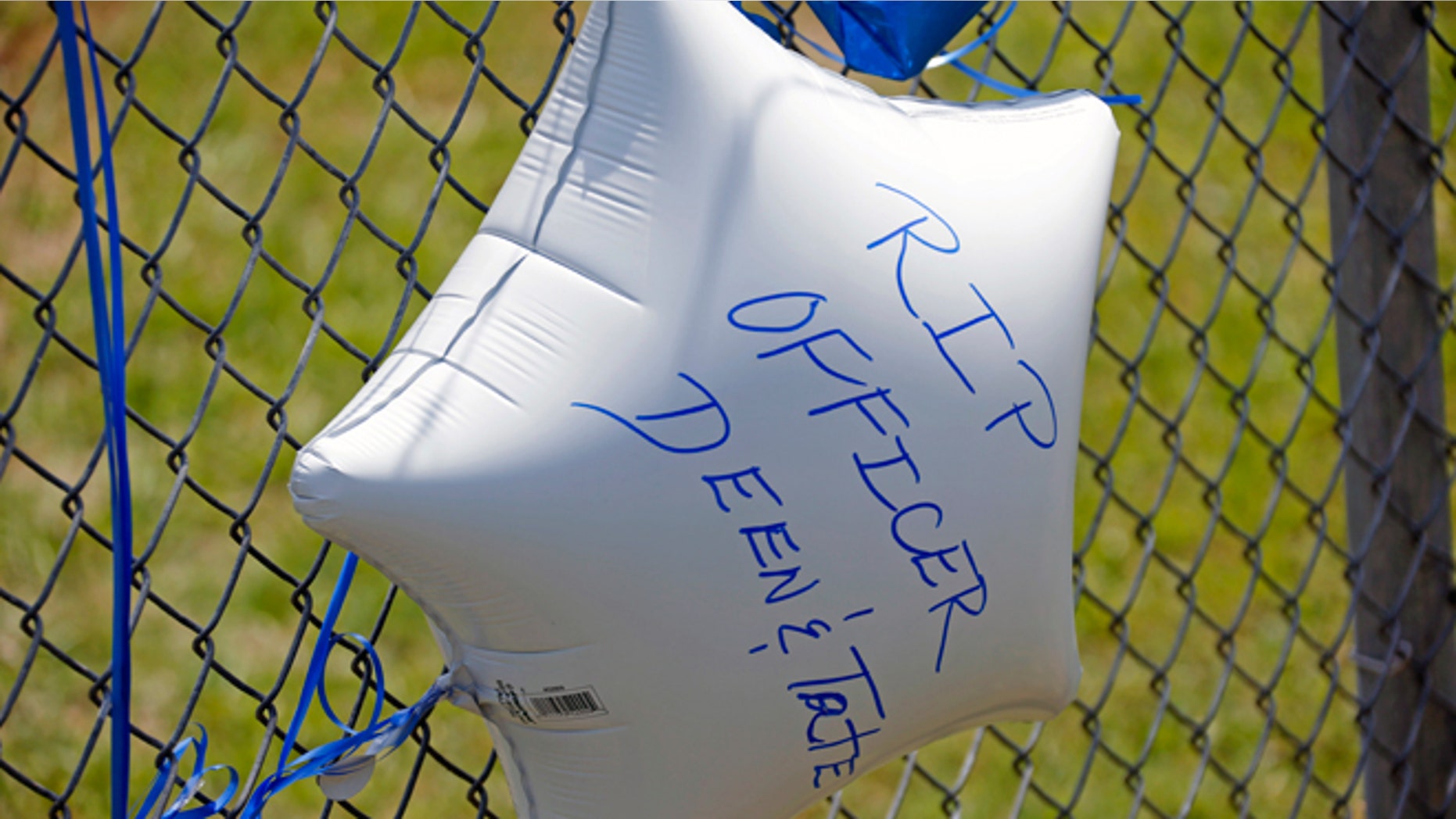 May 10, 2015: A memorial balloon with a personal message floats at a makeshift memorial in Hattiesburg, Miss. Two officers were shot to death during an evening traffic stop turned violent, a state law enforcement spokesman said Sunday. Three suspects were in custody, including two who are charged with capital murder. AP Photo/Rogelio V. Solis