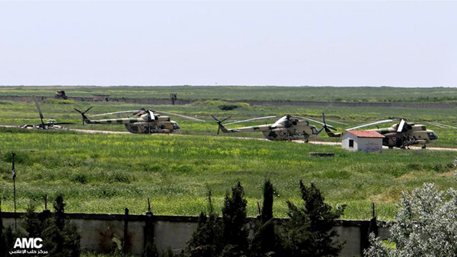 June 18, 2013: This file photo, citizen journalism image provided by Aleppo Media Center AMC which has been authenticated based on its contents and other AP reporting, shows Syrian military helicopters at Mannagh air base in Aleppo province, Syria.