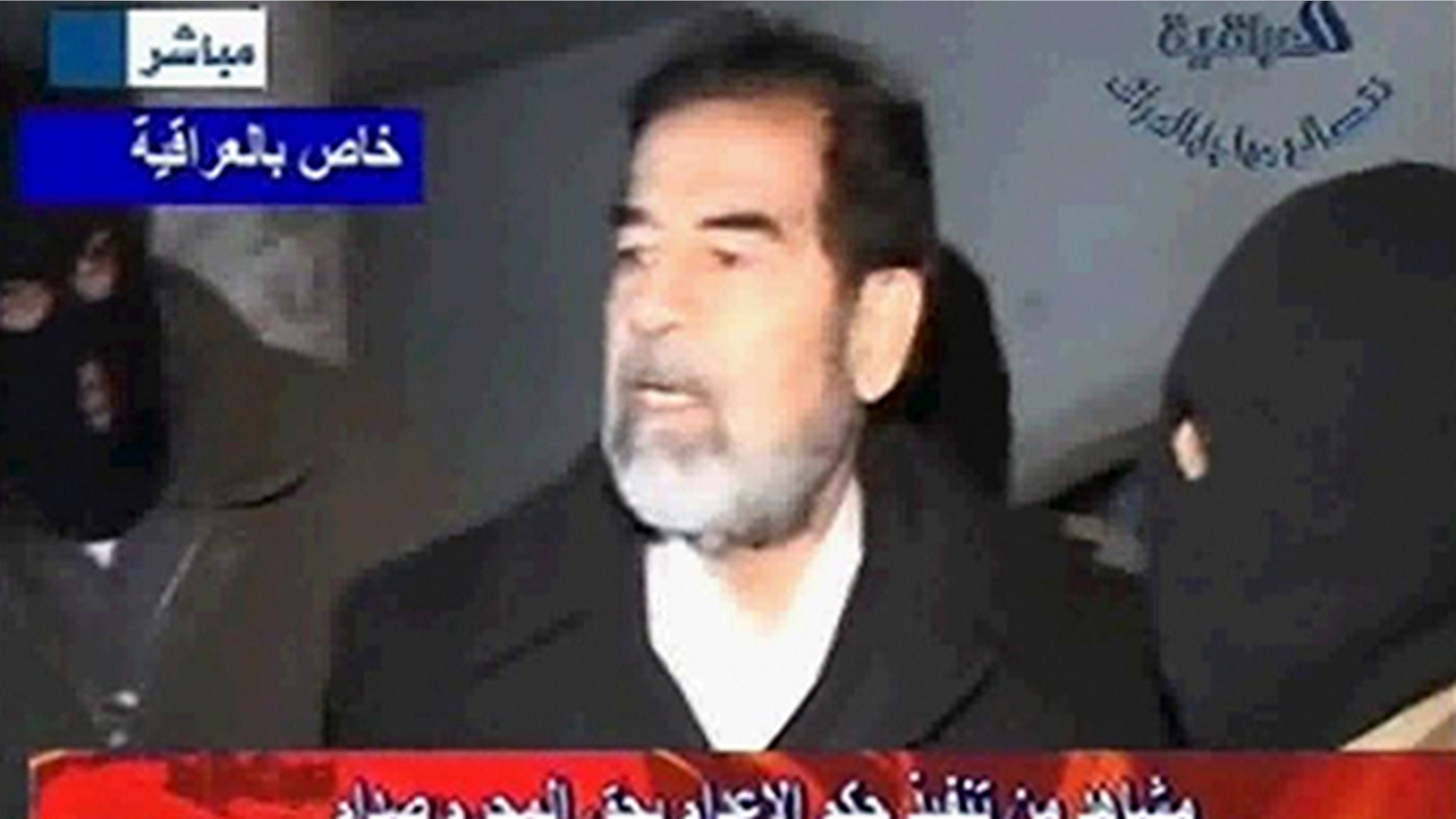 Dec. 30, 2006: A frame grab from Al Iraqiya television shows former Iraqi president Saddam Hussein speasking to his masked executors shortly before his hanging.