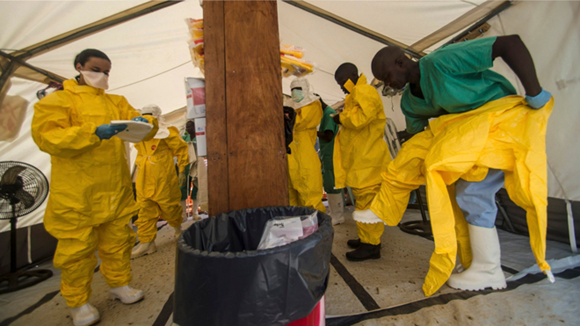 Medical staff working with Medecins sans Frontieres (MSF) put on their protective gear before entering an isolation area at the MSF Ebola treatment centre in Kailahun July 20, 2014. Sierra Leone now has the highest number of Ebola cases, at 454, surpassing neighbouring Guinea where the outbreak originated in February. Picture taken July 20, 2014. REUTERS/Tommy Trenchard (SIERRA LEONE - Tags: HEALTH) - RTR40DKX