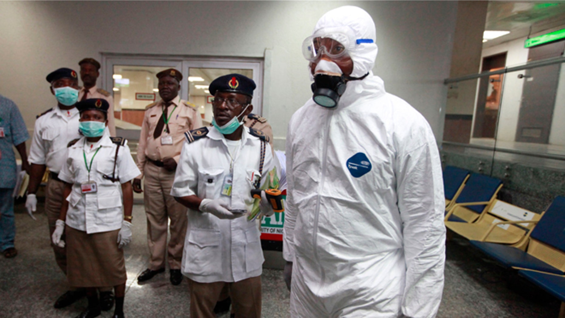 Nigerian health officials wait to screen passengers at the arrival hall of Murtala Muhammed International Airport in Lagos, Nigeria, Monday, Aug. 4, 2014. Nigerian authorities on Monday confirmed a second case of Ebola in Africa's most populous country, an alarming setback as officials across the region battle to stop the spread of a disease that has killed more than 700 people. (AP Photo/Sunday Alamba)