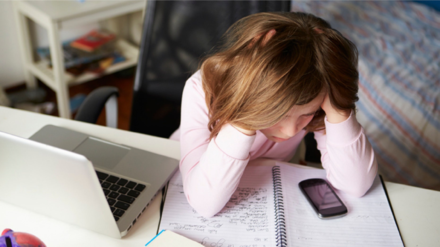 Girl Using Mobile Phone Instead Of Studying In Bedroom