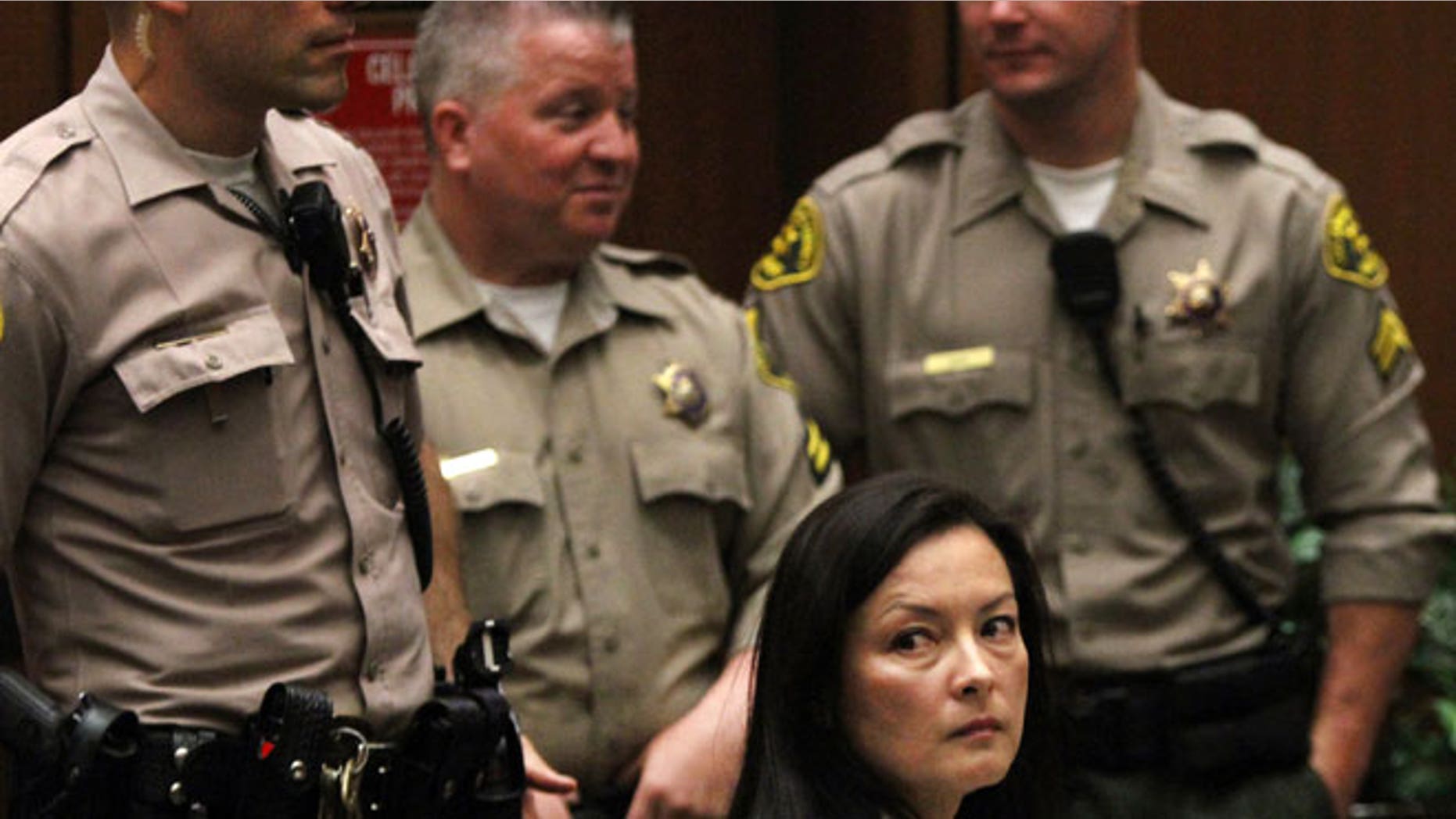 In this May 15, 2013 file photo, Kelly Soo Park looks back at the gallery as opening motions are made in her murder trial. Park was then charged with the 2008 killing of aspiring model and actress Juliana Redding. Los Angeles prosecutors say Park and Dr. Munir Uwaydah are both charged in a conspiracy to fraudulently bill insurance companies $150 million.