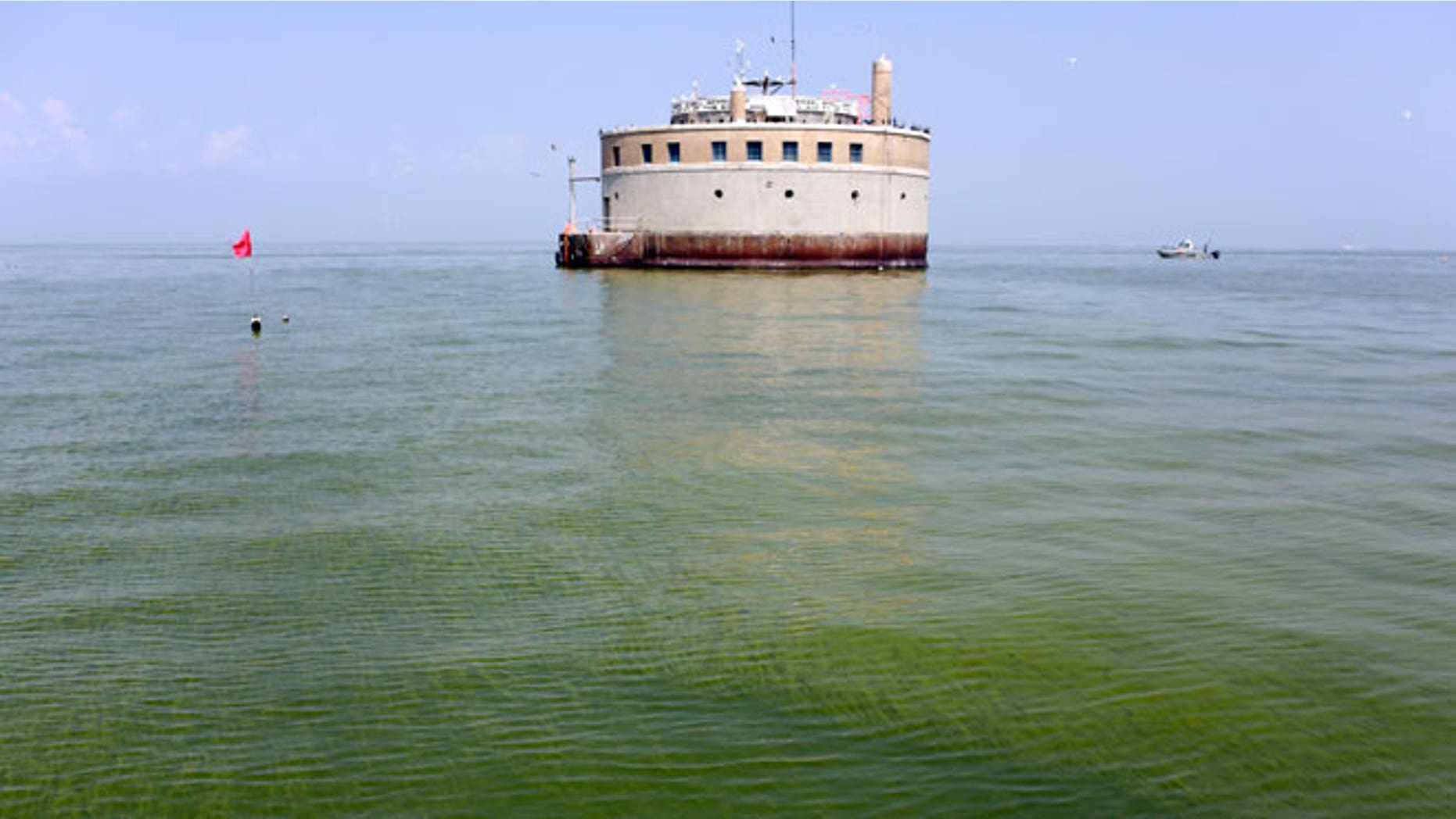 In this Aug. 3, 2014, file photo, the City of Toledo water intake crib is surrounded by algae in Lake Erie, about 2.5 miles off the shore of Curtice, Ohio. Toledo has detected the first signs in Lake Erie of the dangerous toxin that resulted in a water crisis last year that left 400,000 people in northwestern Ohio and southeastern Michigan without safe tap water for two days announced Monday, July 27, 2015.