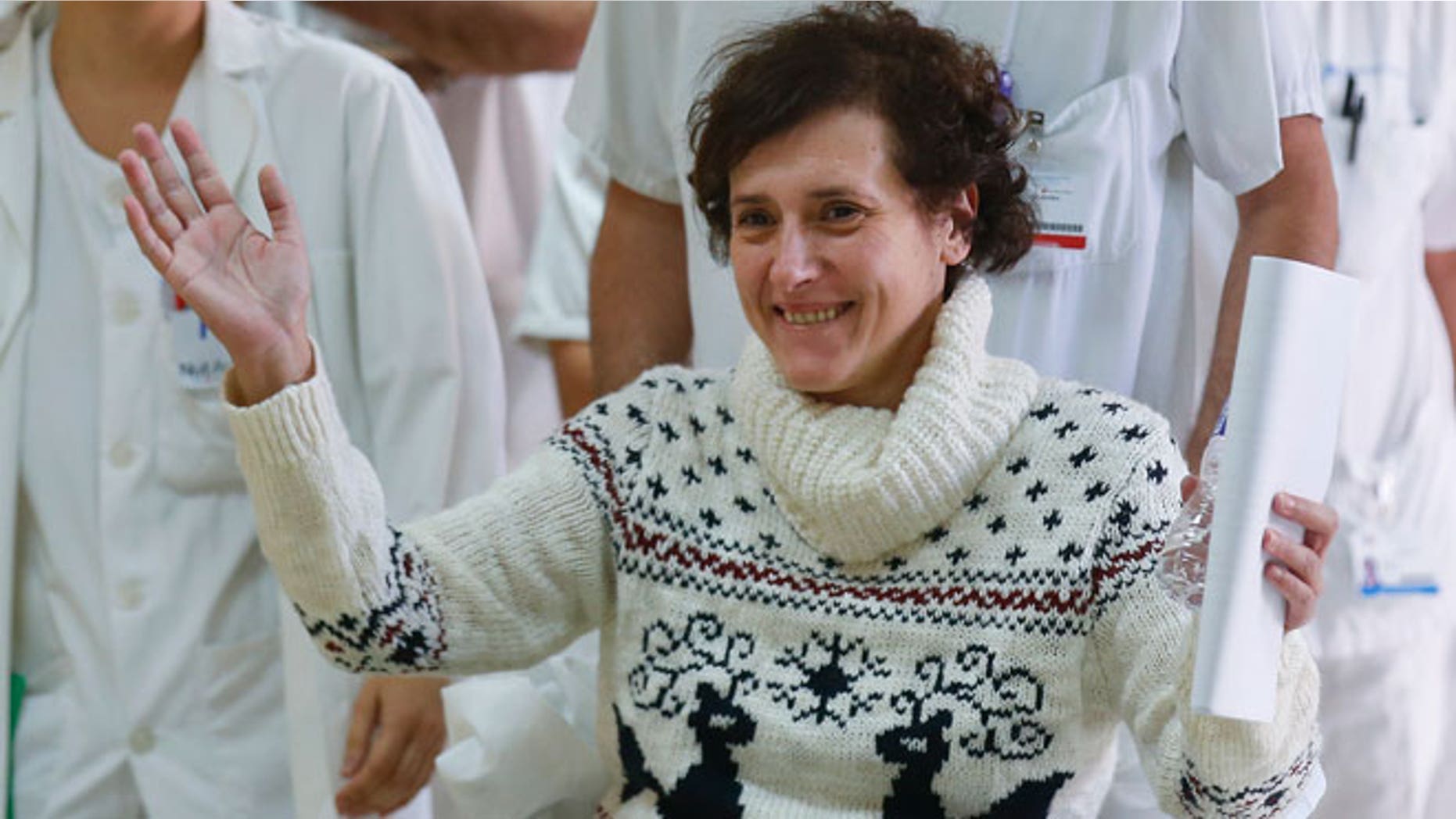 Spanish nurse Teresa Romero who contracted Ebola raises her arms after being discharged from the Carlos III hospital in Madrid, November 5, 2014.