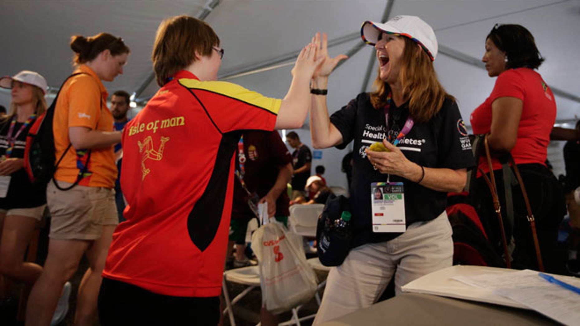 Volunteer Monique Peterson, right, high-fives an athlete from the Isle of Man after a balance test at the 2015 Special Olympics World Games, Tuesday, July 28, 2015, in Los Angeles. Organizers say many of these intellectually challenged athletes have never been examined by a doctor of any kind. Since it began in 1968, the Special Olympics' Healthy Athletes program has provided free medical services to more than 1.6 million people with intellectual disabilities.