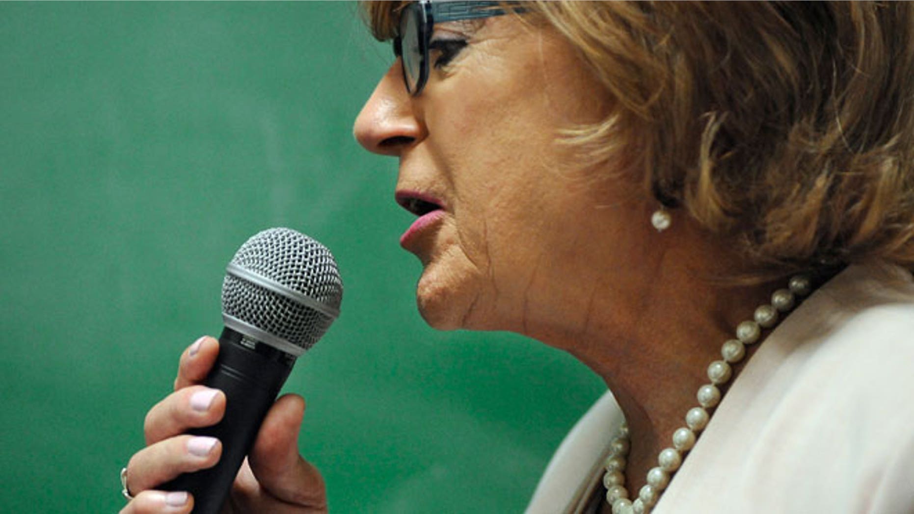 In this July 22, 2015 photo, Brianne Roberts speaks into a microphone during a voice exercise at the University of Connecticut's Speech and Hearing Clinic in Storrs, Conn. Roberts is in a program at UConn that teaches transgender people how to sound more like the sex they identify with.