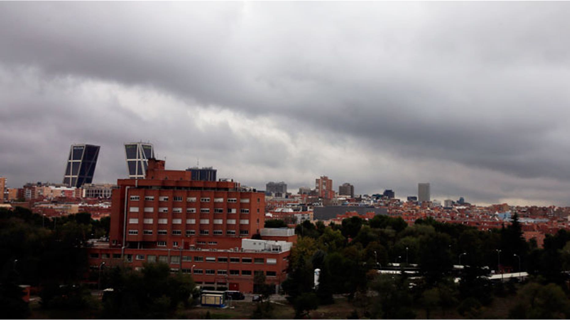 Rainy clouds pass over Madrid's Carlos III Hospital (L, brick building), where Spanish nurse Teresa Romero Ramos who contracted Ebola is hospitalized, in Madrid October 11, 2014.