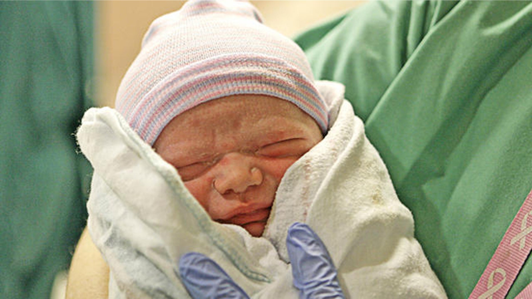 Noah Benton Markham is held by his father Glen Markham just after the birth at St. Tammany Parish Hospital in Covington, La., Tuesday, Jan. 16, 2007. Rebekah Markham was pregnant with an embryo that was rescued from a hospital in the aftermath of Hurricane Katrina. (AP Photo/Alex Brandon)