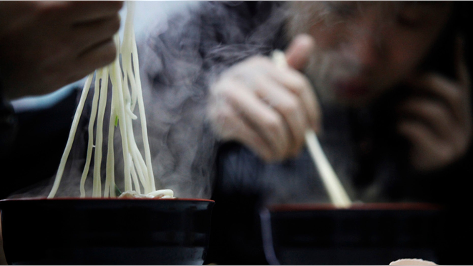 People eat noodles in a restaurant in Shanghai March 2, 2009. China said on Monday food security remains "grim" despite campaigns launched after several health scares, the most recent last year's tainted milk formula which killed at least six toddlers and made almost 300,000 sick. REUTERS/Aly Song (CHINA)