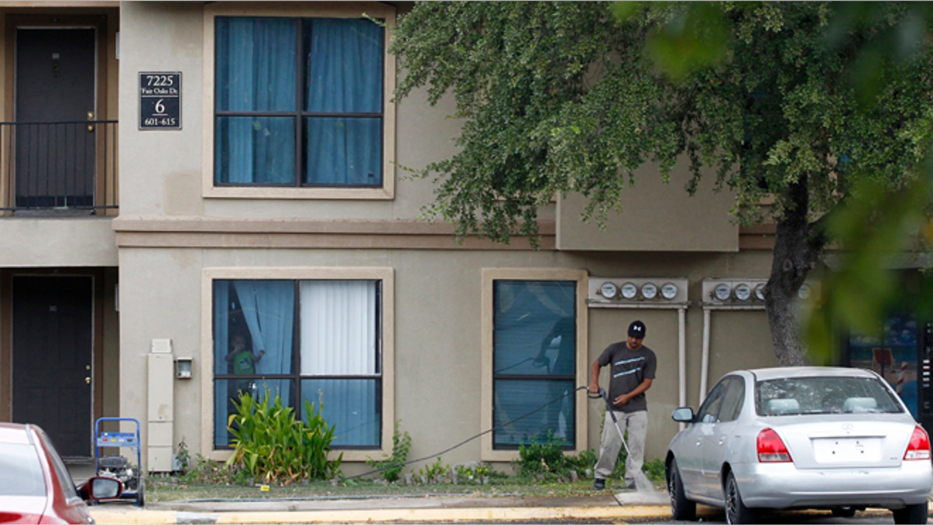 Oct. 2, 2014: A worker washes the sidewalk in front of the apartment unit at The Ivy Apartments, where a man diagnosed with the Ebola virus was staying in Dallas. (REUTERS/Mike Stone)