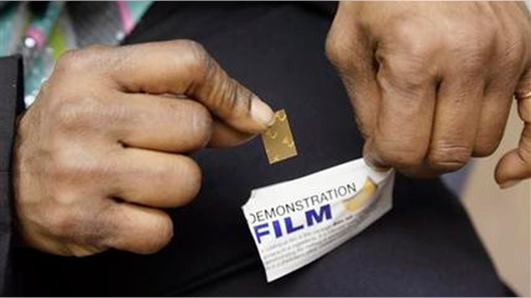 FILE - In this March 11, 2013 file photo, Shavonne Bullock, a recovering heroin addict, holds a demonstration dose of the medication Suboxone during an appointment at the West Division Family Health Center in Chicago. Each dose is incorporated on a dissolvable film, which is placed below the tongue where is dissolves and is absorbed into the bloodstream. Suboxone helps suppress withdrawal symptoms and reduce cravings for people recovering from addiction to opioid drugs. (AP Photo/M. Spencer Green, File)