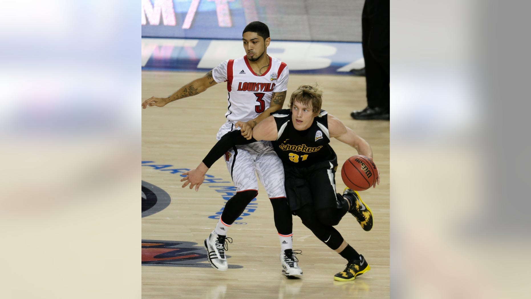 Wichita State's Ron Baker (31) moves around Louisville's Peyton Siva (3) during the first half of the NCAA Final Four tournament college basketball semifinal game Saturday, April 6, 2013, in Atlanta. (AP Photo/Chris O'Meara)