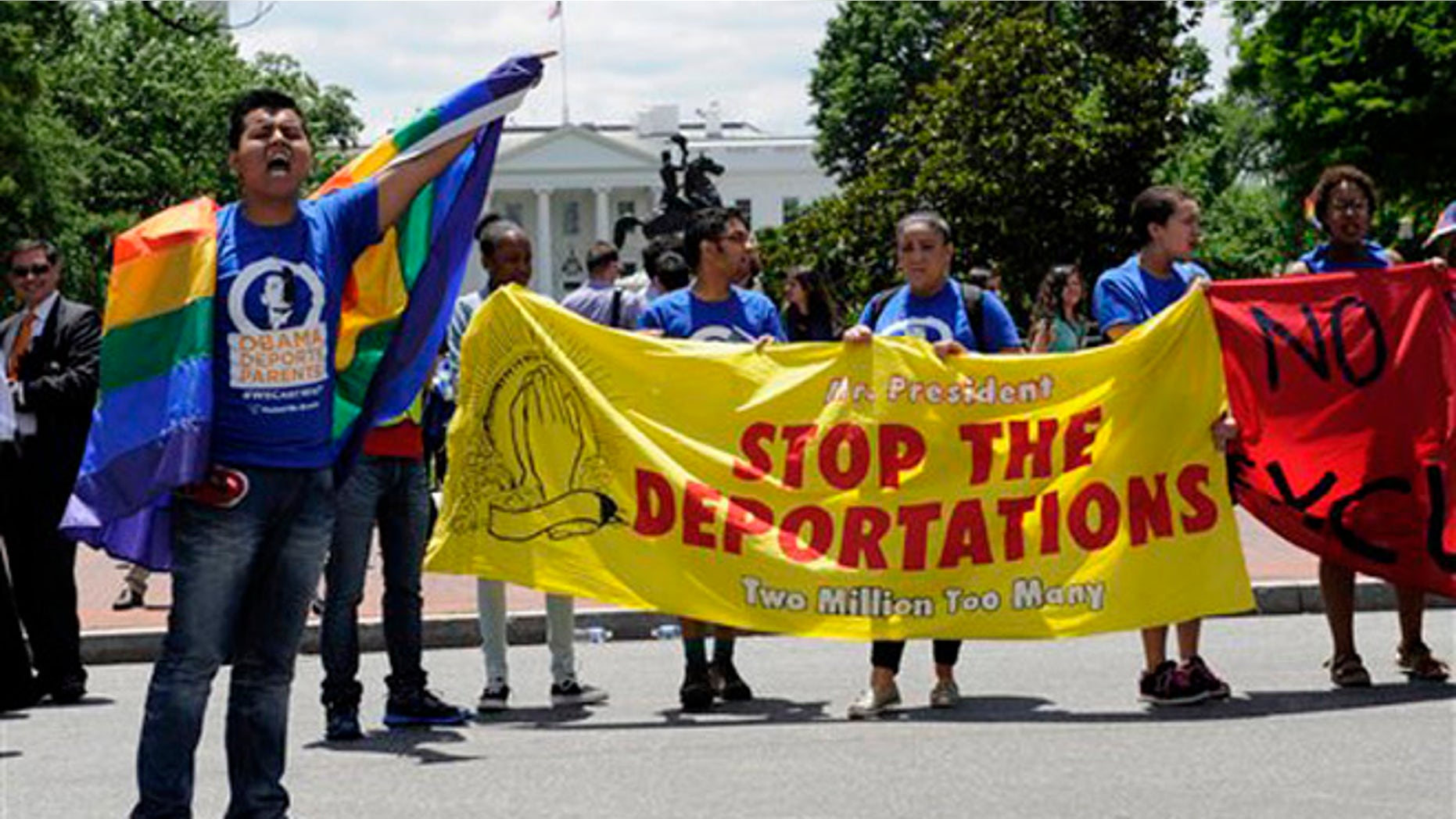Carlos Padilla of Seattle, left, joins protestors as they block traffic near the White House in Washington, Thursday, June 5, 2014, during an deportation demonstration. In response to President Obamaâs decision to delay the deportation review he ordered from the Department of Homeland Security, United We Dream protested near the White House to highlight the urgency of the administration acting now. (AP Photo/Susan Walsh)