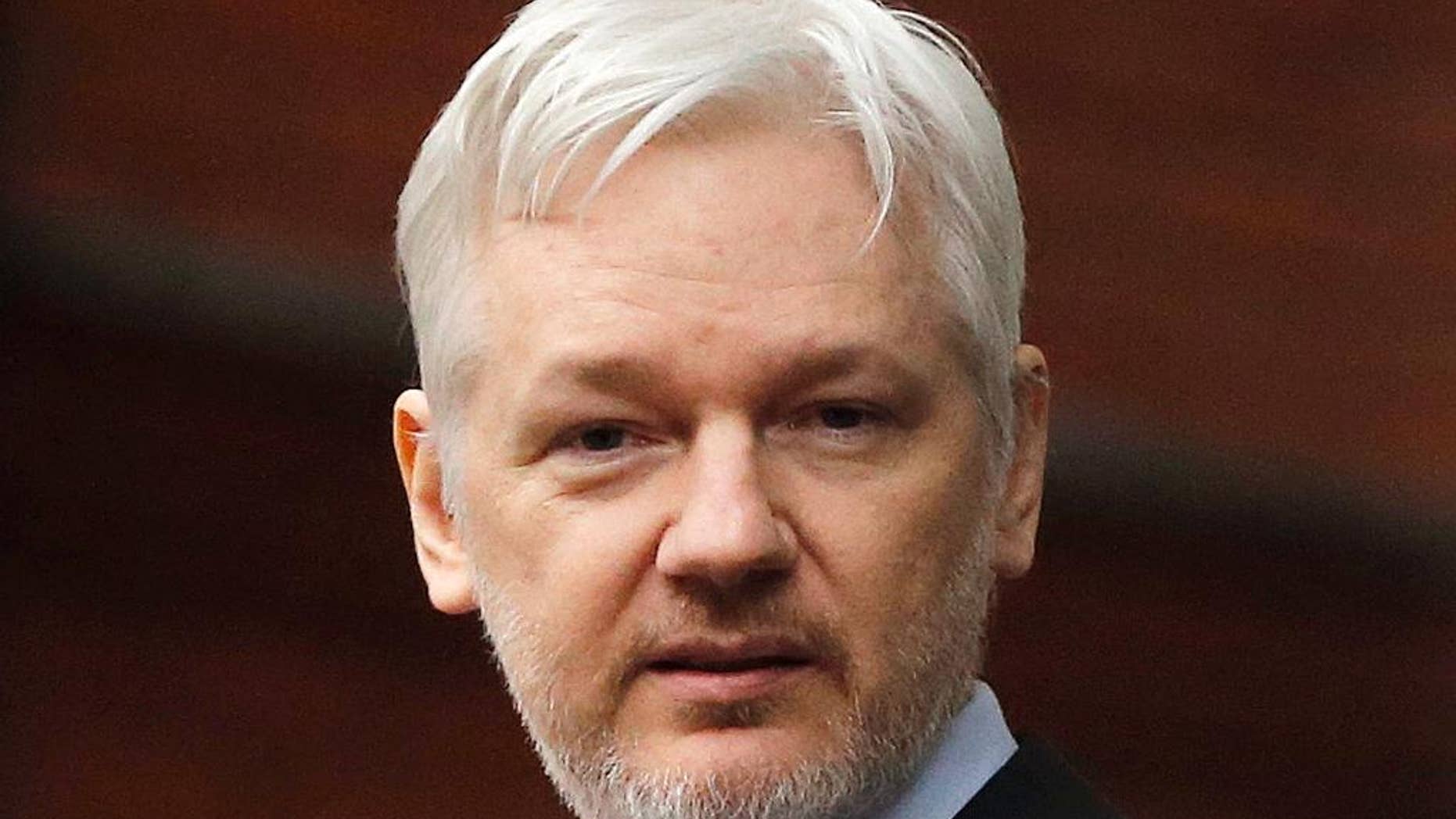 FILE - In this Feb. 5, 2016, file photo, WikiLeaks founder Julian Assange stands on the balcony of the Ecuadorean Embassy in London. Assange is celebrating the results of Ecuador’s presidential runoff with a blast at the losing candidate who had pledged to evict him from Ecuador’s embassy in London. Assange has been holed up at the diplomatic mission since 2012, when President Rafael Correa granted him asylum. (AP Photo/Frank Augstein, File)