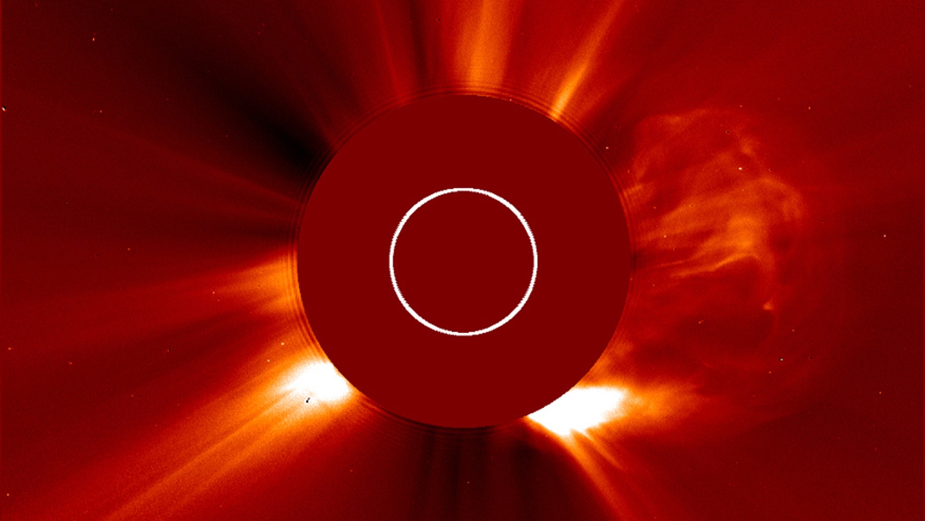 On the right side, a cloud of solar material ejects from the sun in one of the fastest coronal mass ejections (CMEs) ever measured.