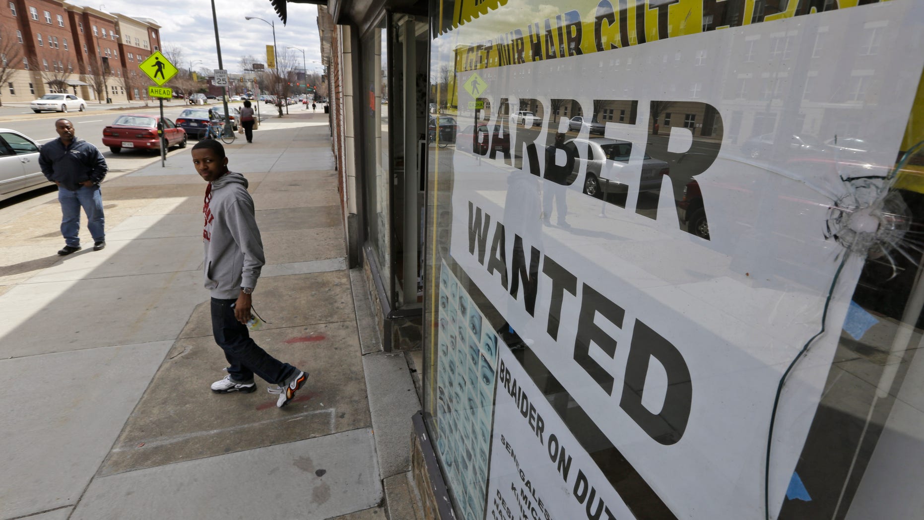 FILE - This Friday, March 29, 2013 file photo shows a help wanted sign at a barber shop in Richmond, Va. U.S. employers added just 88,000 jobs in March, the fewest in nine months and a sharp retreat after a period of strong hiring. Many discouraged Americans are giving up the job hunt for school, retirement and disability. (AP Photo/Steve Helber, File)