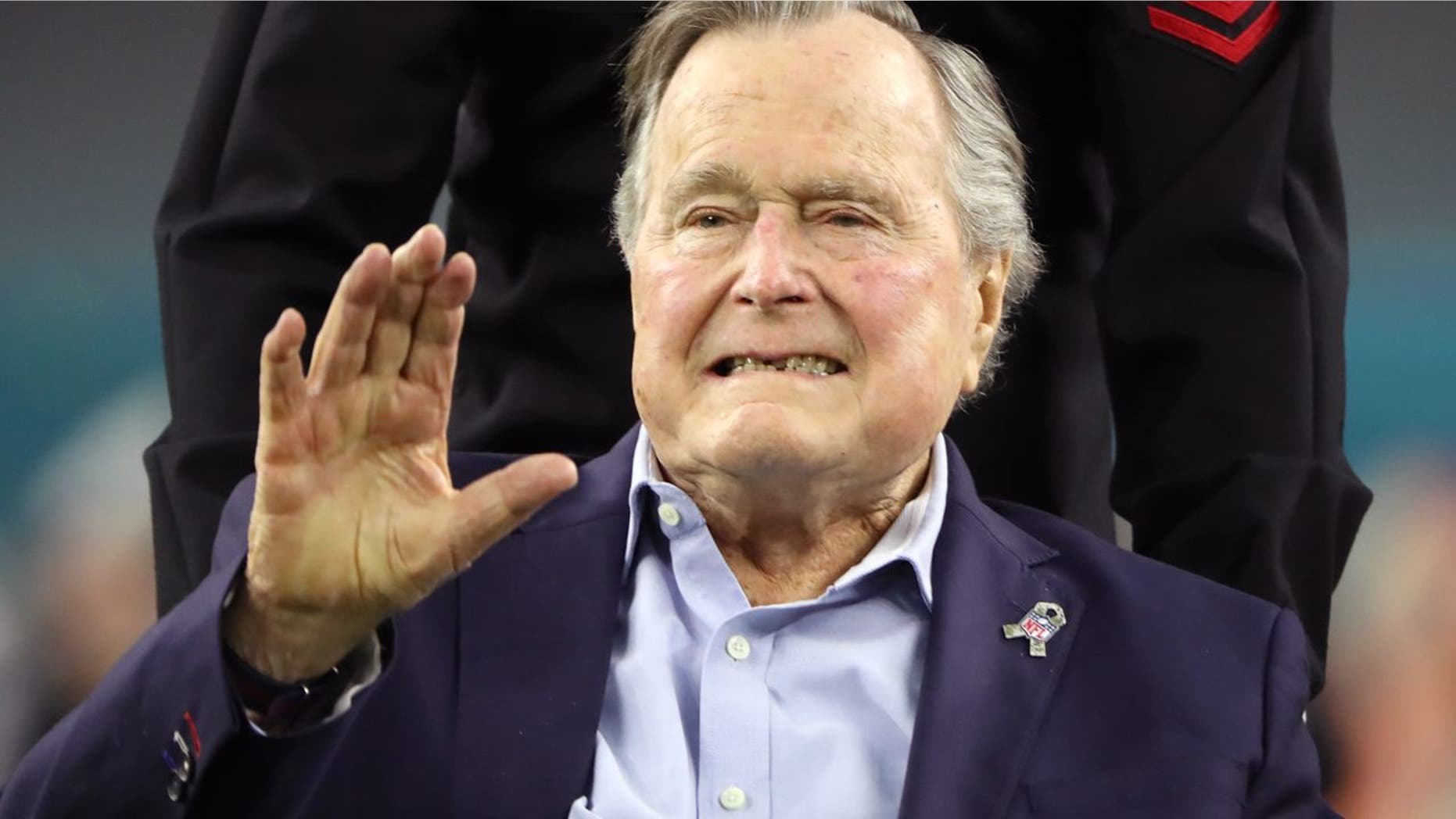 Former U.S. President George H.W. Bush arrives on the field to do the coin toss ahead of the start of Super Bowl LI between the New England Patriots and the Atlanta Falcons in Houston, Texas, U.S., February 5, 2017. REUTERS/Adrees Latif - HT1ED251U8502