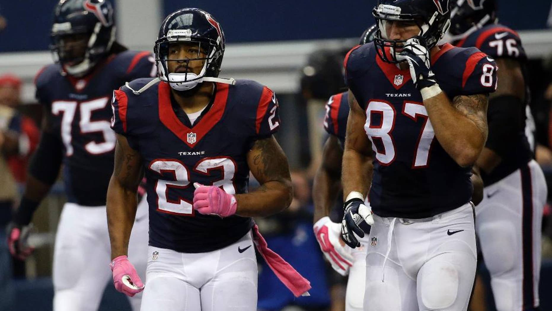 Houston Texans' Arian Foster (23) and C.J. Fiedorowicz (87) run back to the sideline after Foster ran the ball in for a touchdown against the Dallas Cowboys during the second half of an NFL football game, Sunday, Oct. 5, 2014, in Arlington, Texas. (AP Photo/Tim Sharp)