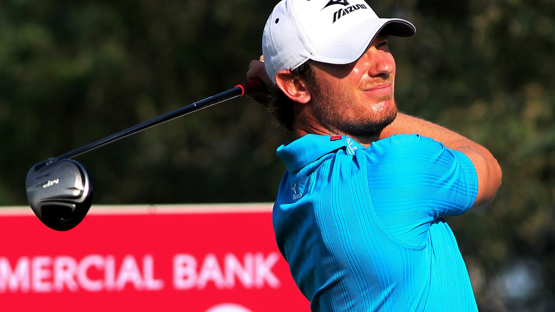 Chris Wood of England plays his shot on the 18th hole during the third round of the Commercial Bank Qatar Masters held at the Doha Golf Club in Qatar, Friday, Jan. 25, 2013. (AP Photo/Osama Faisal)