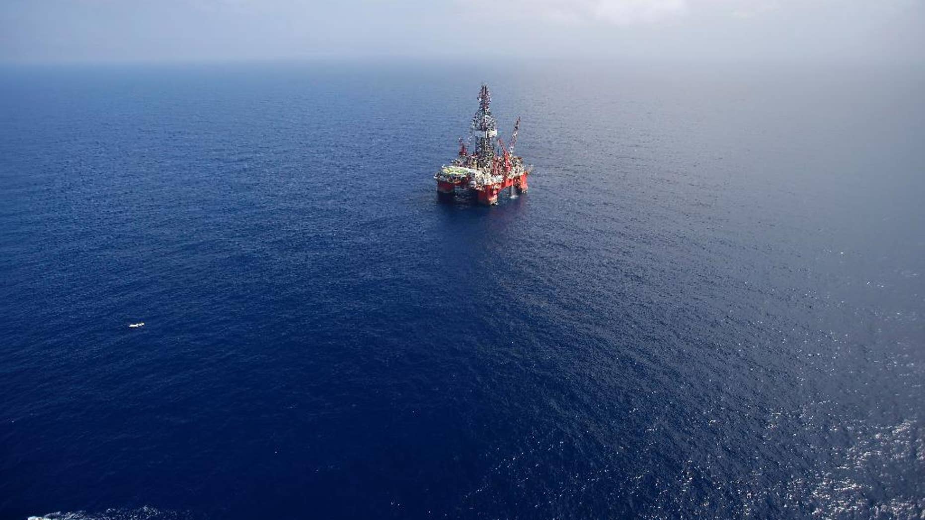 FILE - In this Nov. 22, 2013, file photo, the Centenario deep-water drilling platform stands off the coast of Veracruz, Mexico in the Gulf of Mexico. Mexico's government announced on Thursday, Dec. 11, 2014 the start of bidding for oil exploration rights in 14 areas of the Gulf of Mexico being opened to domestic and international companies as it ends a seven-decade state monopoly on the petroleum business. (AP Photo/Dario Lopez-Mills, File)
