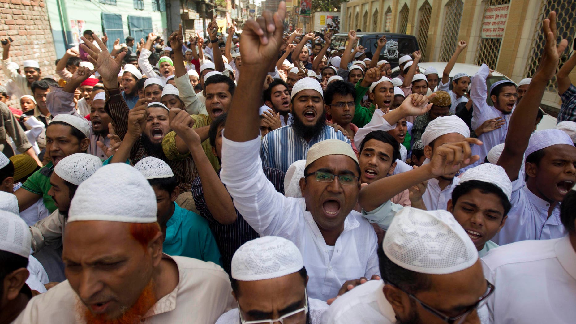 Activists of Hifazat-e Islam shout slogans during a rally in support of the Long March, a march from Chittagong to Dhaka, in Dhaka, Bangladesh, Friday, April 5, 2013. A number of activists under the banner of Hifazat-e Islam are set to start their long march from Chittagong to Dhaka Saturday on foot to protest against Bangladeshi bloggers who they allege are hurting religious sentiments of the country's Muslim majority. (AP Photo/A.M. Ahad)