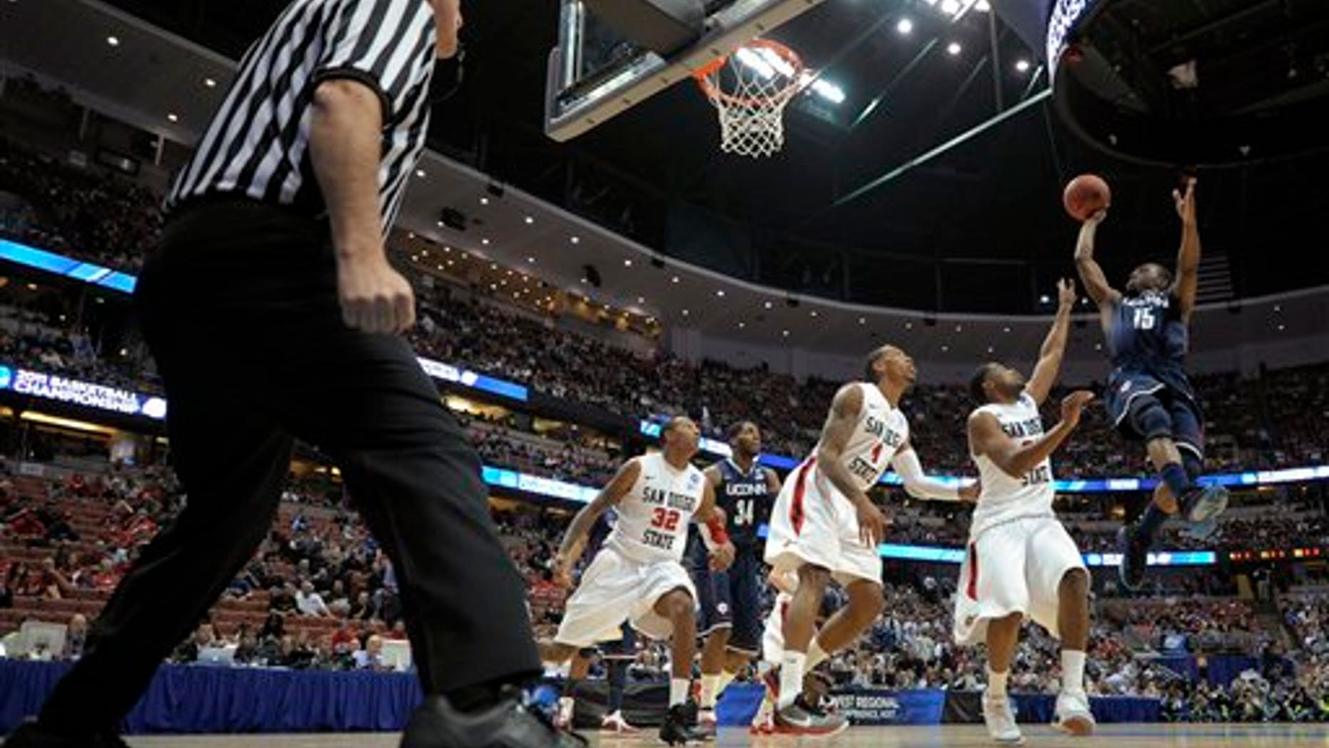 March 24: Connecticut's Kemba Walker (15) shoots over San Diego State's Chase Tapley, Malcolm Thomas (4), Billy White (32) during the first half of a West regional semifinal in the NCAA college basketball tournament in Anaheim, Calif. (AP)