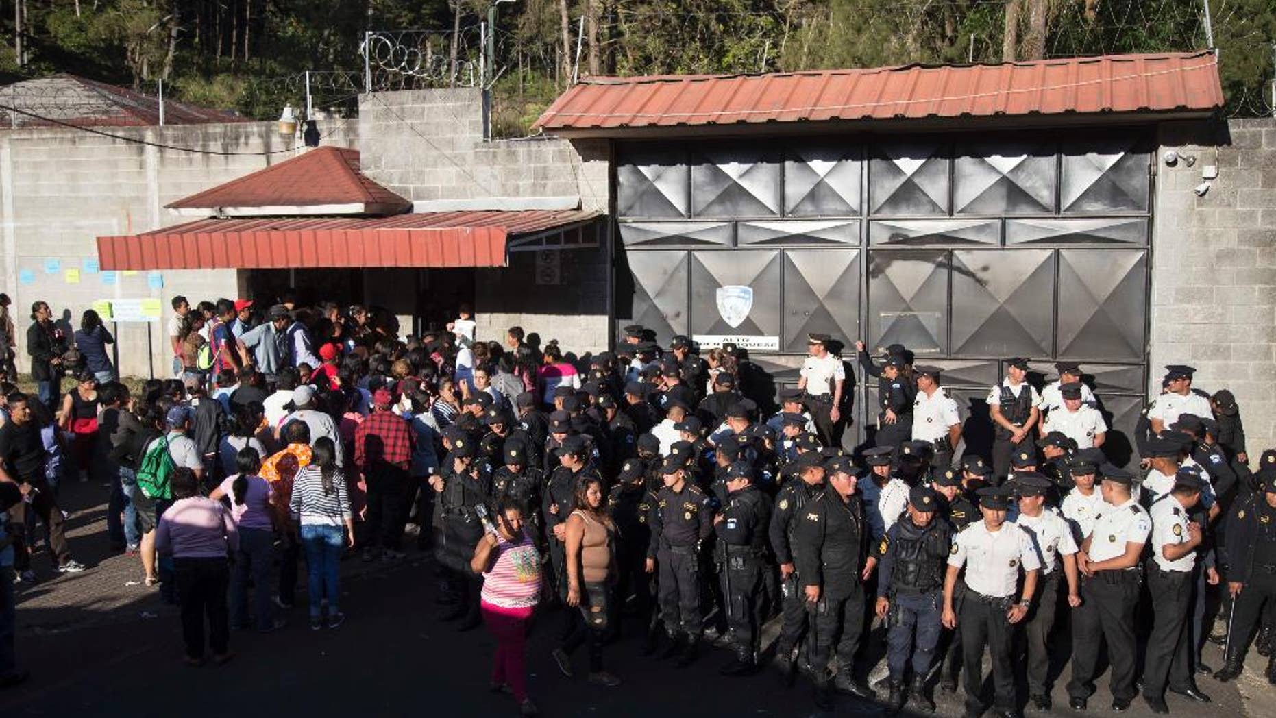 FILE - In this March 8, 2017 file photo, National Police guard the entrance to the Virgen de la Asuncion Safe Home, in San Jose Pinula, Guatemala. In November, a state human rights prosecutor filed a complaint with the Inter American Human Rights Commission charging rampant abuses at the shelter. The accusations included charges as serious as "forced recruitment for human trafficking for the purpose of prostitution." (AP Photo/Luis Soto, File)
