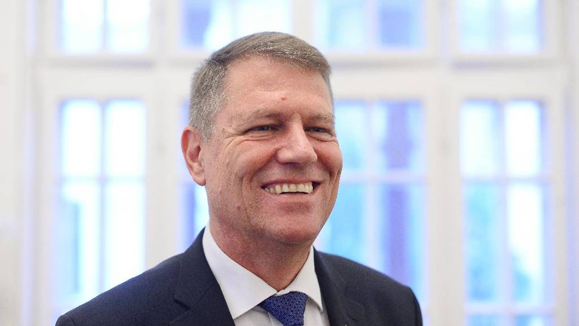 Klaus Iohannis, leader of Romania's center-right Liberals and mayor of the Transylvanian city of Sibiu, smiles while posing for a portrait, shortly after giving an interview to the Associated Press, on the first morning after exit polls in the presidential elections runoff in Bucharest, Romania, Monday, Nov. 17, 2014. The ethnic German mayor who defeated Romania's Prime Minister Victor Ponta in a presidential runoff said his victory signaled "a deep change" in Romania. (AP Photo/Octav Ganea, Mediafax) ROMANIA OUT