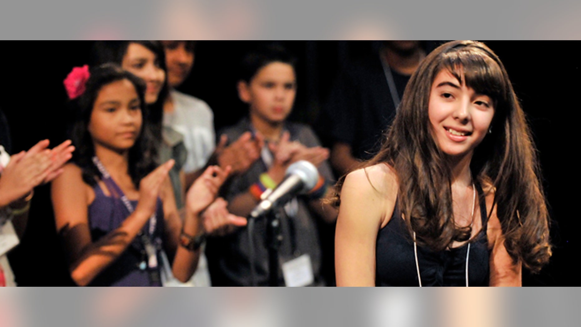 Other contestants applaud Evelyn Juarez, right, a seventh grader from Santa Cruz, New Mexico, who won the First Annual SANTILLANA National Spanish Spelling Bee with the word bizantinismo at the National Hispanic Cultural Center in Albuquerque, NM on Saturday, July 9, 2011. (AP Photo/Albuquerque Journal, Greg Sorber)