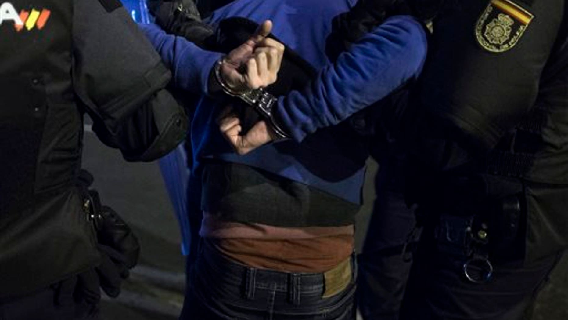 Police arrest a demonstrator during a protest against the government in Madrid, Spain, Saturday, March 22, 2014. Spanish police and protesters clashed during an anti-austerity demonstration that drew tens of thousands of people to central Madrid on Saturday. Police said in a statement six officers were injured and 12 people were arrested. (AP Photo/Andres Kudacki)