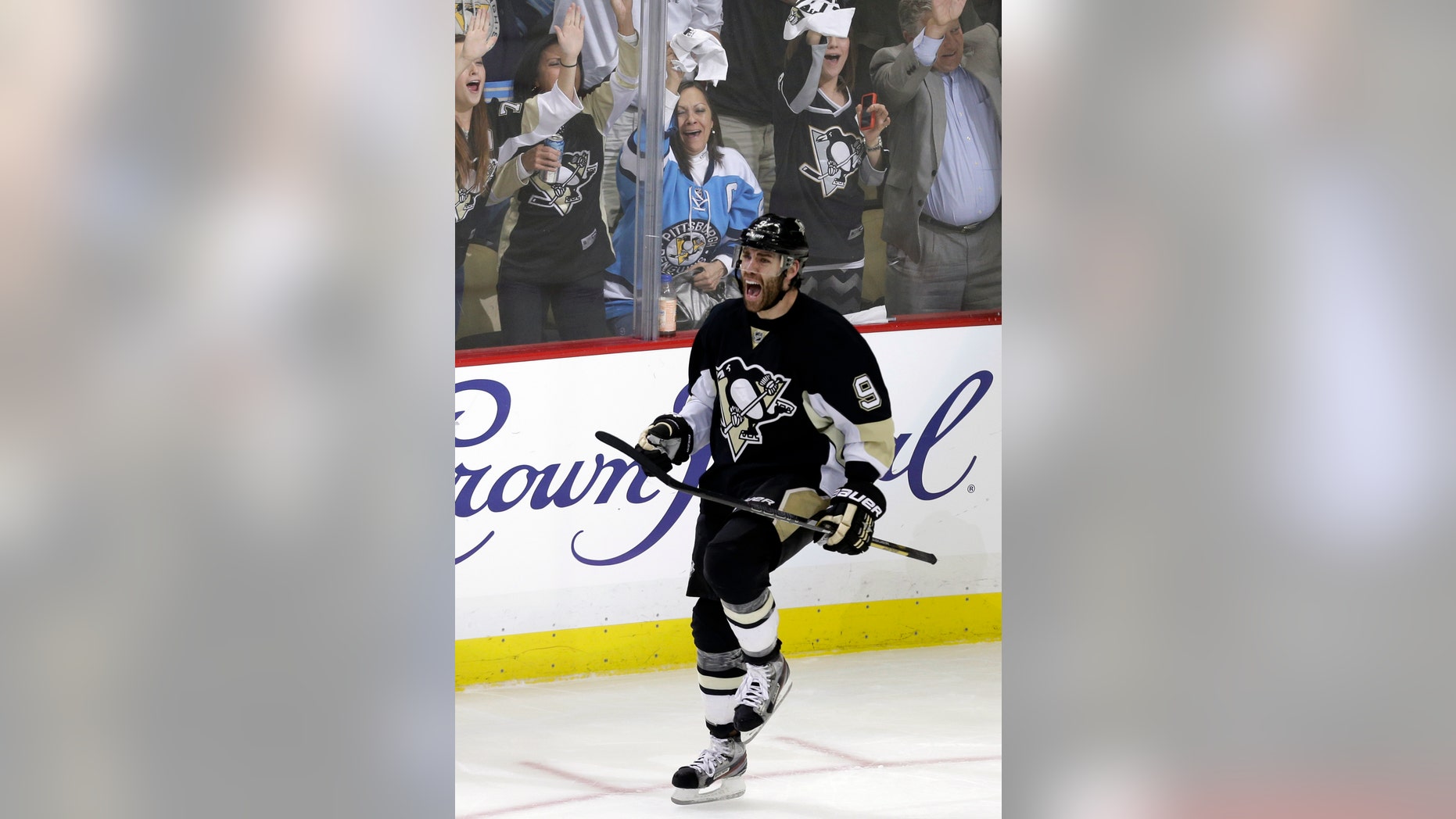 Pittsburgh Penguins' Pascal Dupuis (9) celebrates his short-handed goal in the third period of Game 1 of an NHL hockey Stanley Cup second-round playoff series against the Ottawa Senators in Pittsburgh Tuesday, May 14, 2013. The Penguins won 4-1. (AP Photo/Gene J. Puskar)