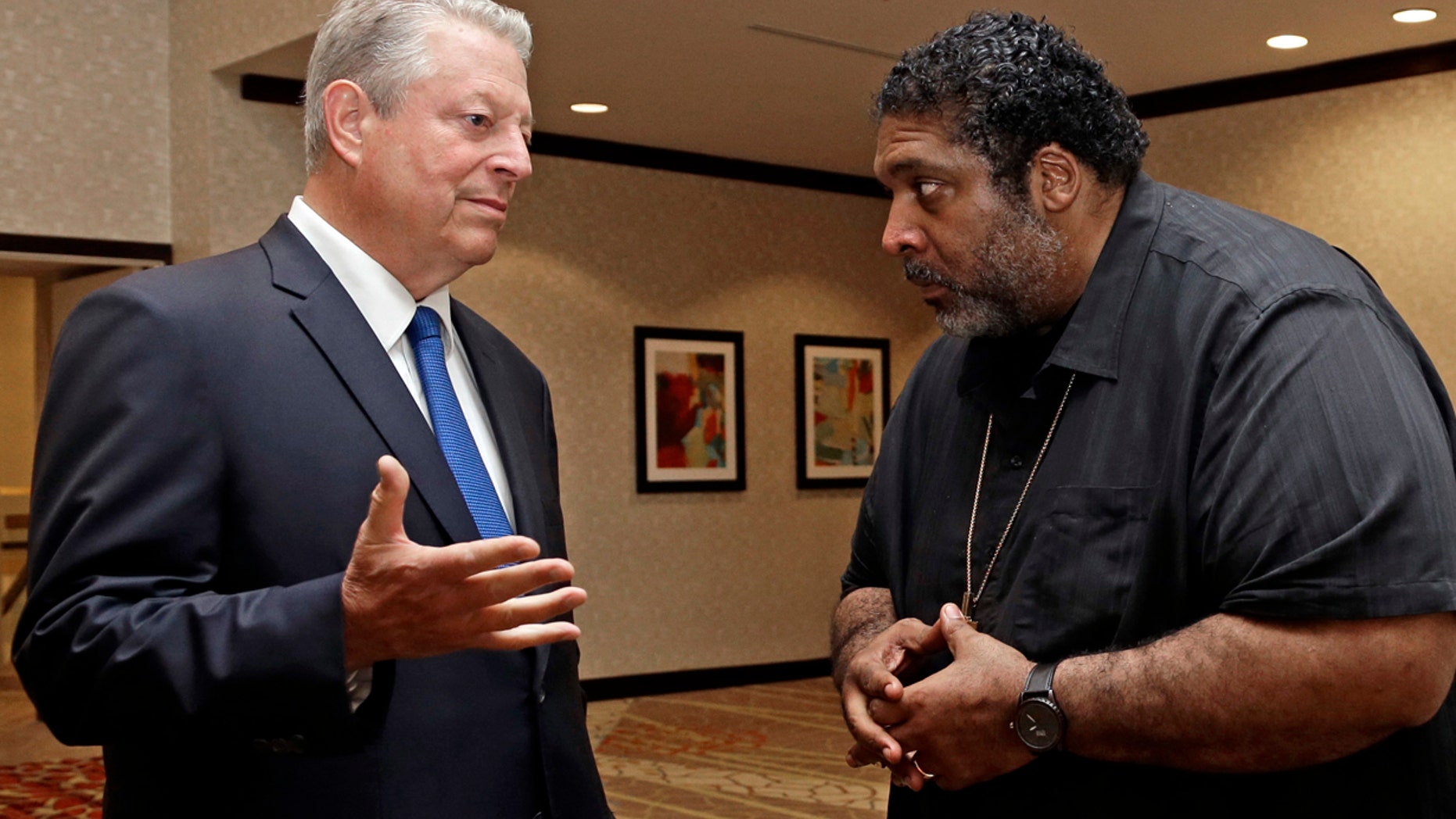 Former U.S. Vice President Al Gore, left, speaks with the Rev. Dr. William J. Barber II in Greensboro, N.C.
