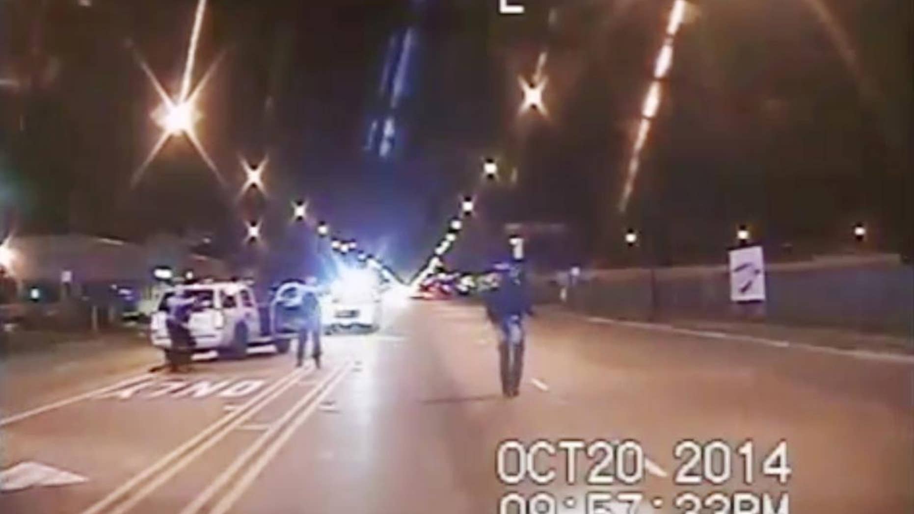 Oct. 20, 2014: In this image from dash-cam video provided by the Chicago Police Department, Laquan McDonald, right, walks down the street moments before being fatally shot by officer Jason Van Dyke sixteen times in Chicago.