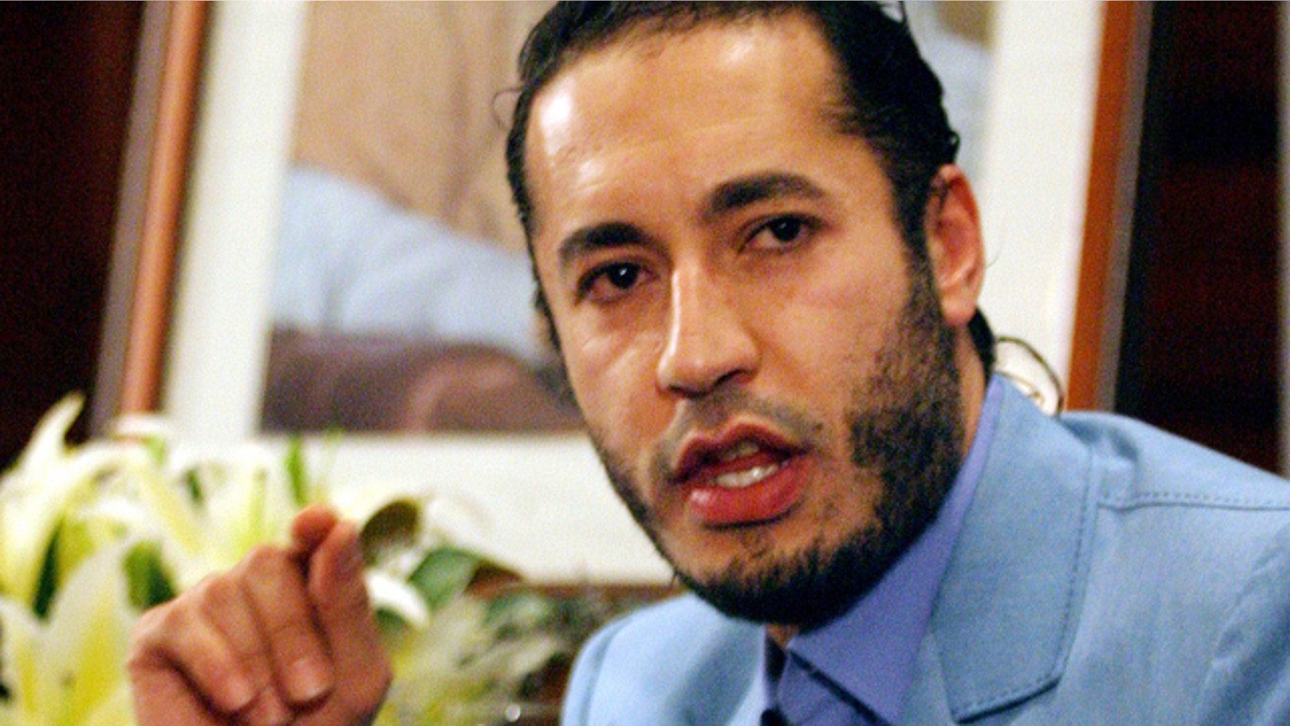 FILE 2005: Al-Saadi Qaddafi, the son of Muammar Qaddafi, answers a question during a press conference in Sydney.