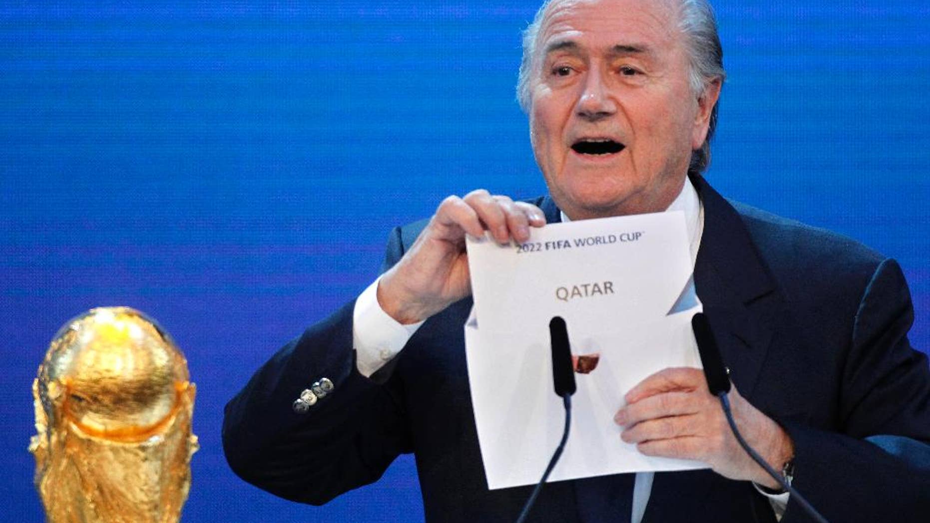 FILE - In this Thursday, Dec.2, 2010 file photo FIFA President Sepp Blatter announces Qatar to host the 2022 soccer World Cup in Zurich, Switzerland. FIFA has cleared Russia and Qatar of any wrongdoing in their winning bids for the next two World Cups. (AP Photo/Michael Probst)