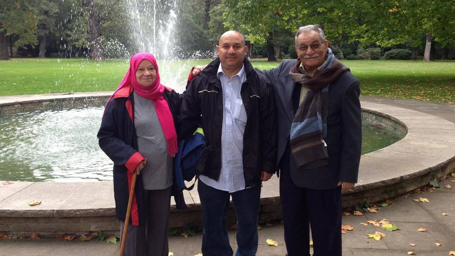 In this undated photograph provided by Ghasan Abdul Hadi, Iraqi Sinan Al-Haboubi, centre, poses with his parents. A lawyer for an Iraqi man who was detained in Poland last summer on terrorism suspicions says his client was freed from prison but immediately taken into custody by border guards, meaning his deportation is likely, it was reported on Monday, May 15, 2017. Al-Haboubi, a 48-year-old Iraqi national who had asylum in Switzerland, was arrested last July for possessing trace amounts of explosives, found on his luggage. The arrest came ahead of a visit to Poland by Pope Francis amid heightened security concerns. (Ghasan Abdul Hadi via AP)