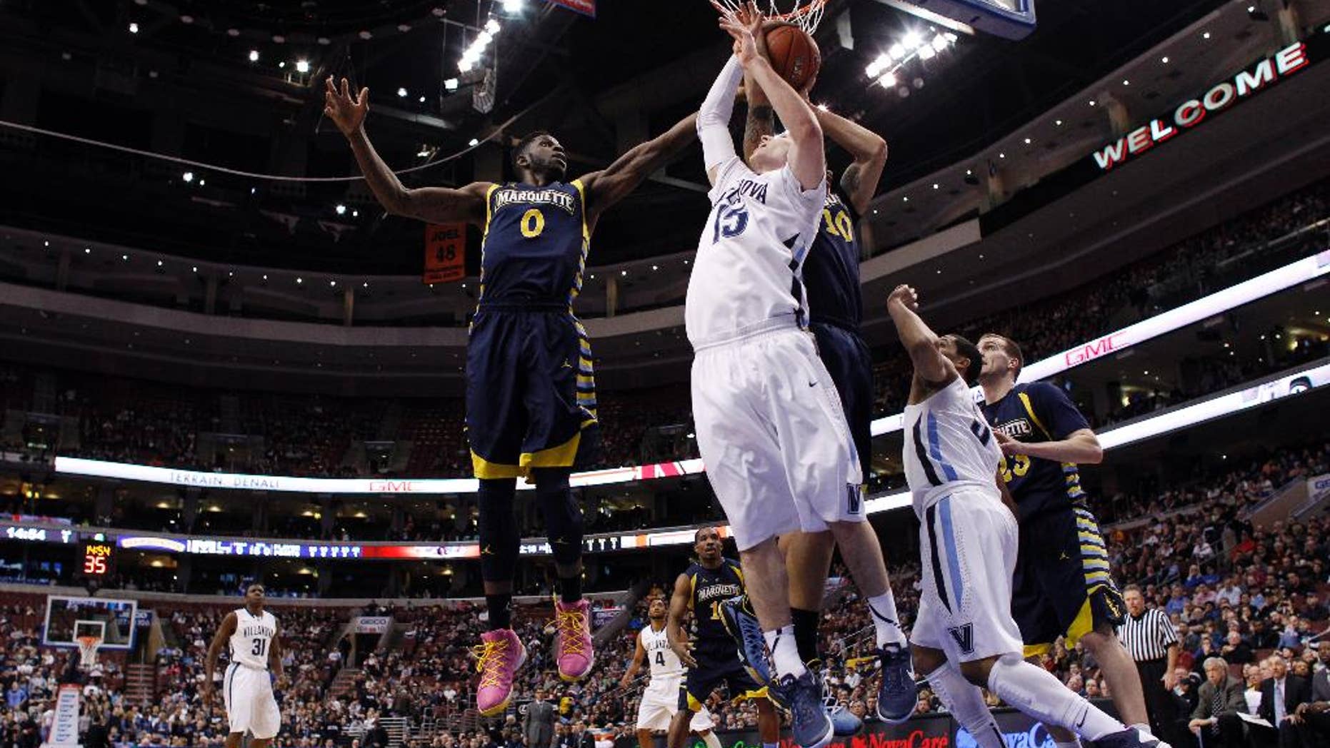 Villanova's Ryan Arcidiacono (15) battles for a rebound against Marquette's Jamil Wilson (0) and Juan Anderson (10) during the first half of an NCAA college basketball game on Sunday, March 2, 2014, in Philadelphia. (AP Photo/Matt Slocum)