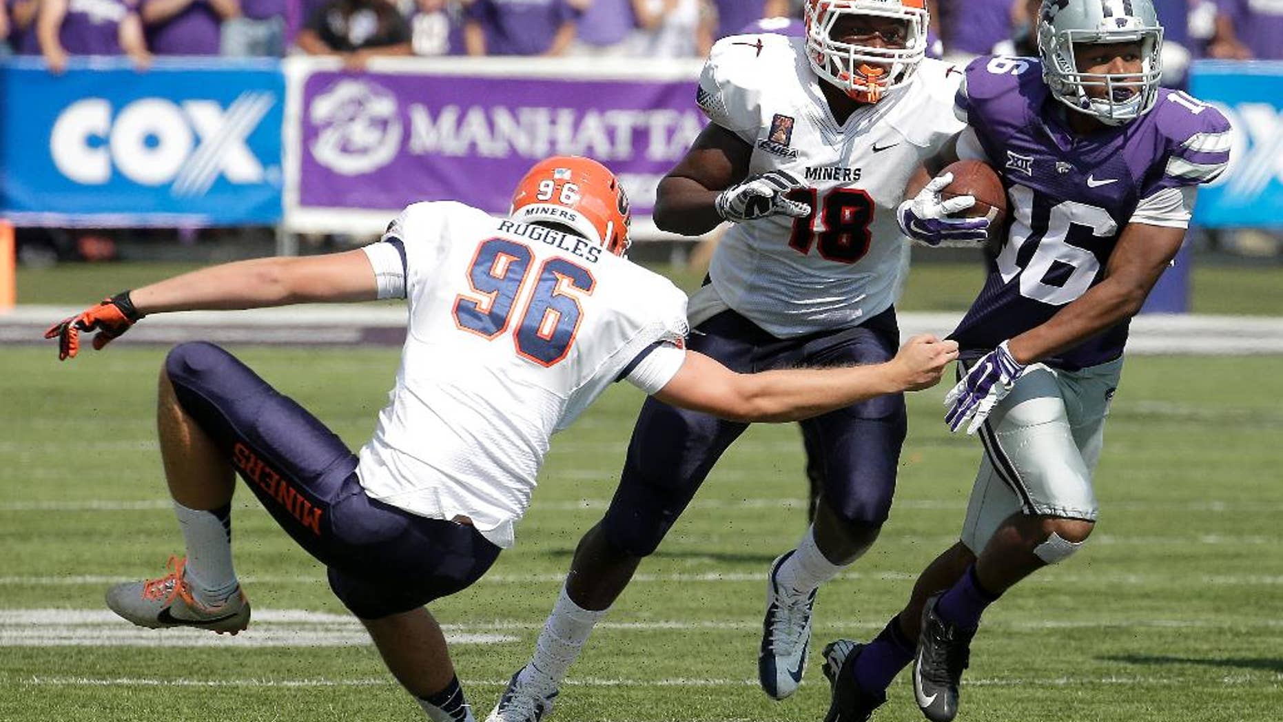 Kansas State wide receiver Tyler Lockett (16) gets past UTEP place kicker Mike Ruggles (96) and tight end Katrae Ford (18) as he returns a punt during the first half of an NCAA college football game, Saturday, Sept. 27, 2014, in Manhattan, Kan. (AP Photo/Charlie Riedel)